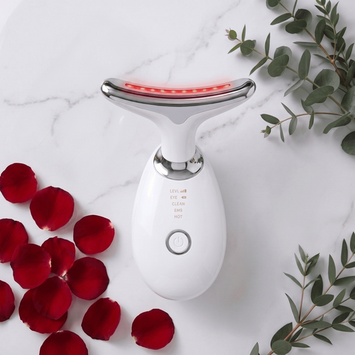 LumiSculpt Pro 7-Color LED Therapy Facial Sculptor in Pearl White on marble with rose petals